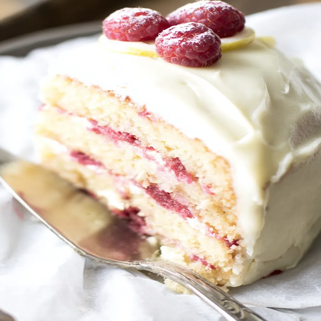 raspberry lemon cake, zesty citrus, moist, fruity, vibrant colors, delicious flavor